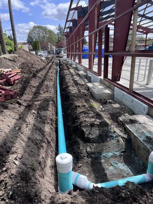 Bob's Property Solutions excavator digging utility lines near Puyallup