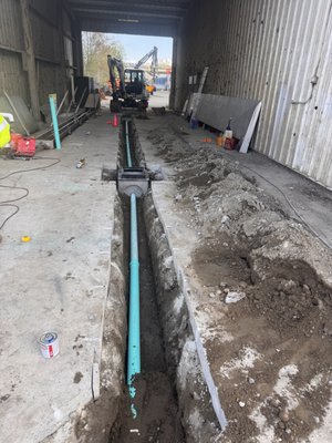 Bob's Property Solutions installing catch basin and drain pipe tied into storm drain