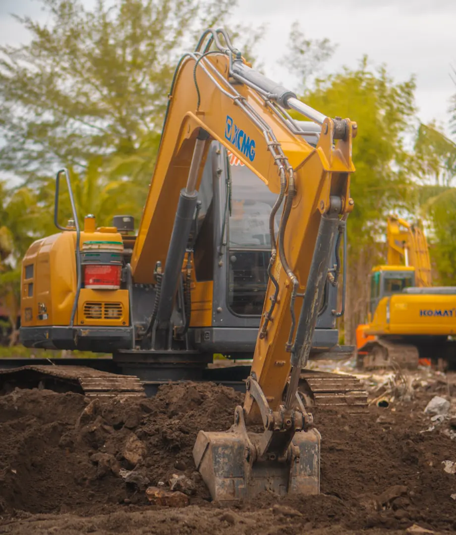 Excavator moving soil while preparing a building site for construction